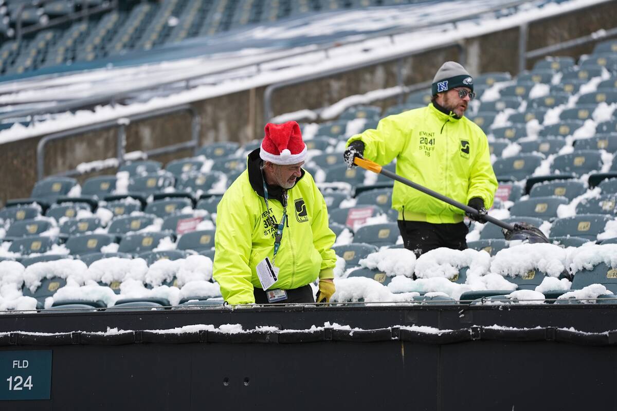 Snow is cleared before an NFL football game between the Philadelphia Eagles and the Las Vegas R ...