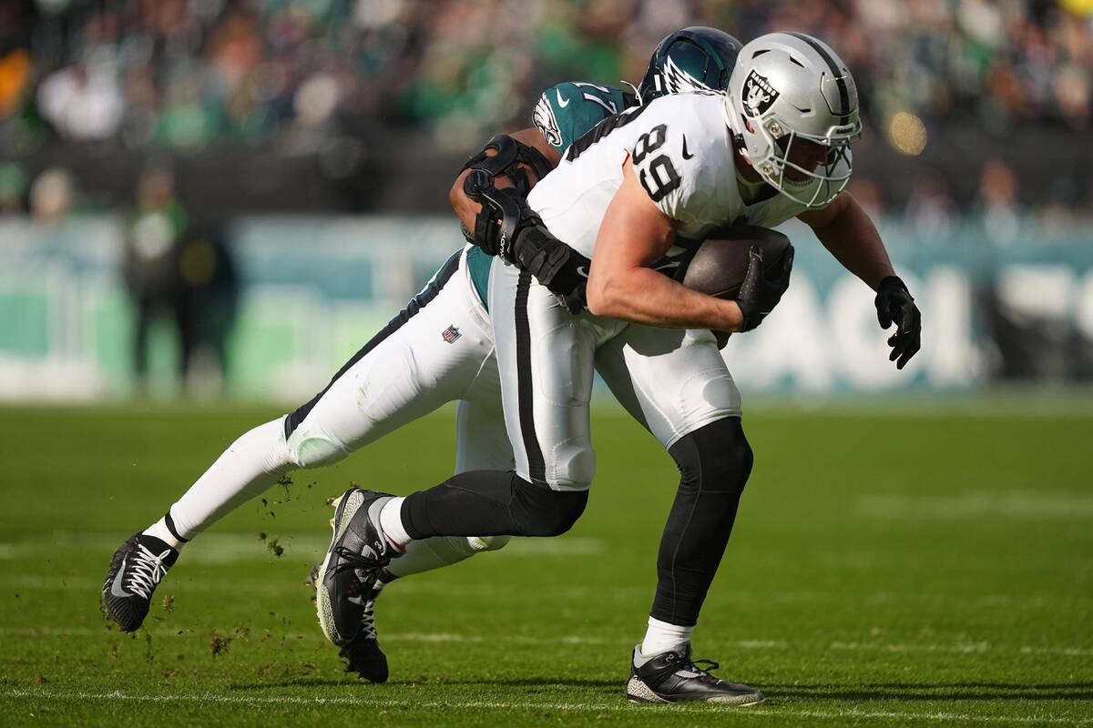 Las Vegas Raiders tight end Brock Bowers (89) is brought down by Philadelphia Eagles linebacker ...