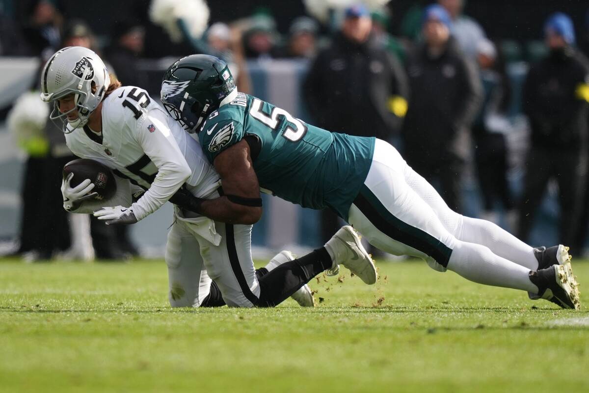 Las Vegas Raiders quarterback Kenny Pickett (15) is tackled by Philadelphia Eagles defensive en ...