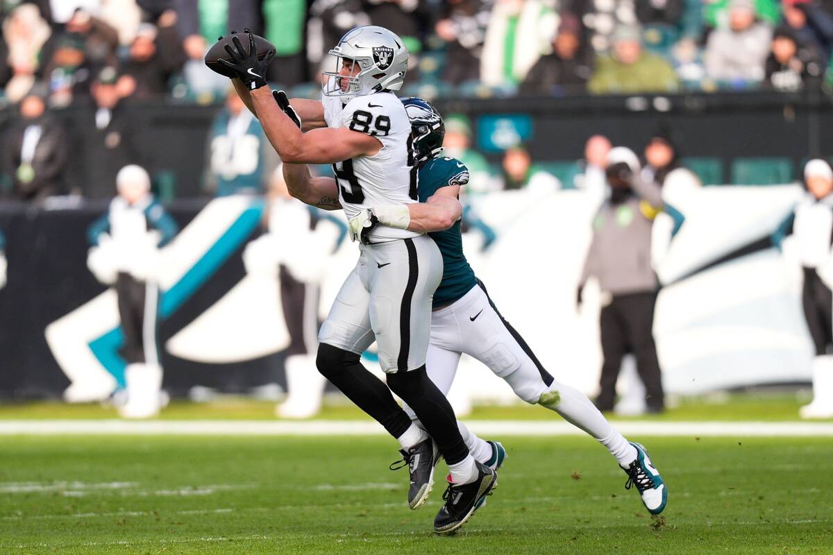 Las Vegas Raiders tight end Brock Bowers (89) catches the ball as he's brought down by Phi ...