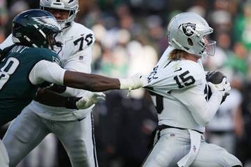 Philadelphia Eagles linebacker Jalyx Hunt (58) grabs Las Vegas Raiders quarterback Kenny Picket ...