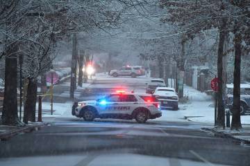 Police vehicles rest in intersections in a neighborhood near Brown University, Sunday, Dec. 14, ...