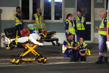 Emergency workers standby at Bondi Beach after a reported shooting in Sydney, Sunday, Dec. 14, ...