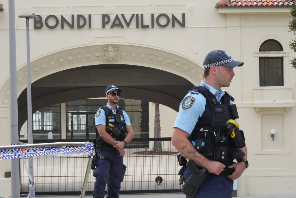 Police patrol in the early morning following a shooting Sunday at Sydney's Bondi Beach, Mo ...