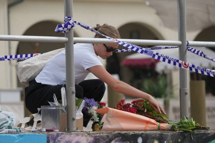 Shenna McClean lays flowers at a memorial at Sydney's Bondi Beach, Monday, Dec. 15, 2025, ...