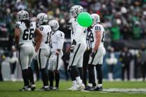 A balloon floats near Las Vegas Raiders players during the first half of an NFL football game a ...
