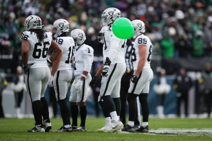 A balloon floats near Las Vegas Raiders players during the first half of an NFL football game a ...