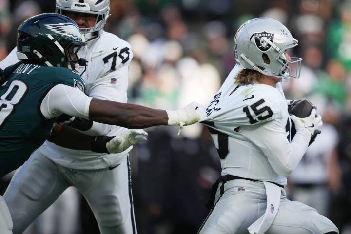 Philadelphia Eagles linebacker Jalyx Hunt (58) grabs Las Vegas Raiders quarterback Kenny Picket ...