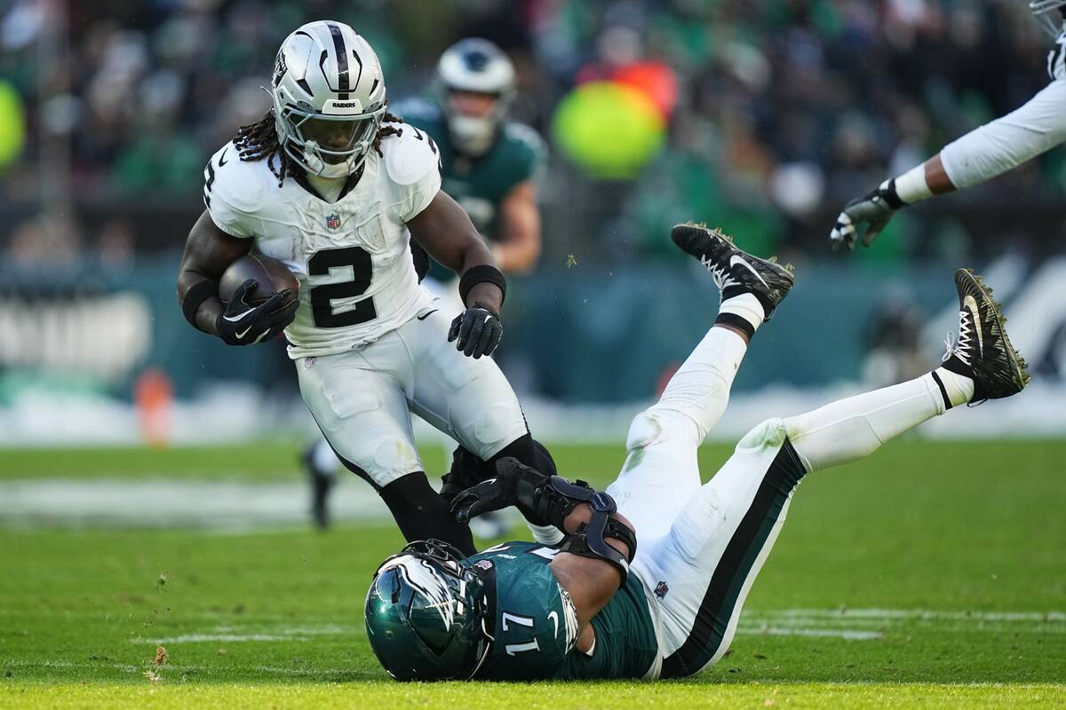 Las Vegas Raiders running back Ashton Jeanty (2) is brought down by Philadelphia Eagles linebac ...
