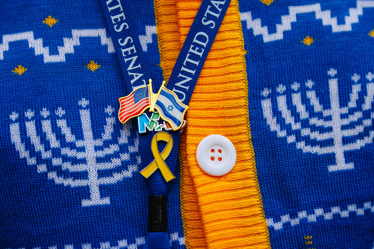Pins are seen on a lanyard during the Fremont Street Experience menorah lighting Sunday, Dec. 1 ...