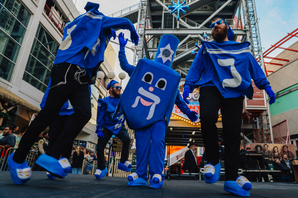 The Dancing Dreidels dance during the Fremont Street Experience menorah lighting Sunday, Dec. 1 ...