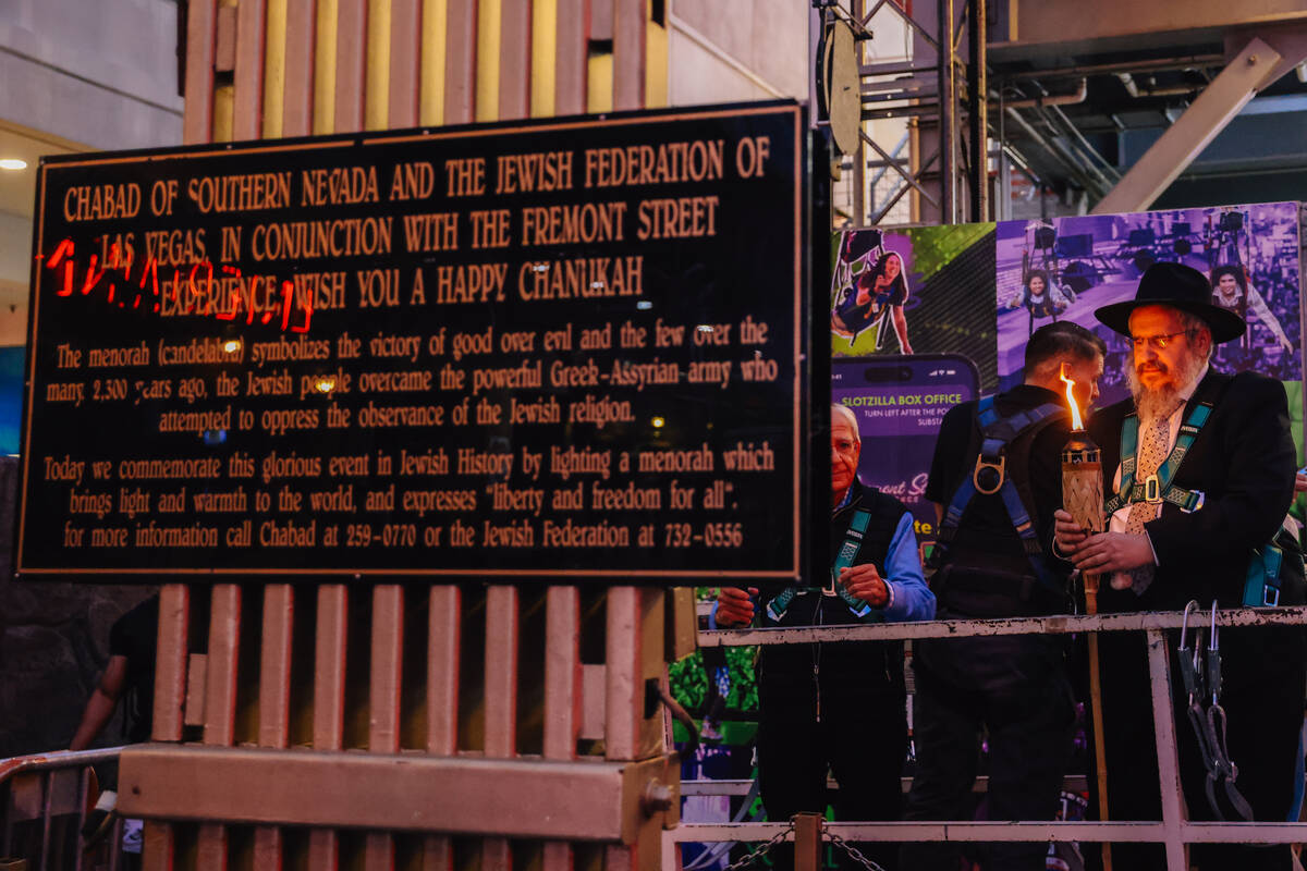 Rabbi Shea Harlig prepares to light the menorah during the Fremont Street Experience menorah li ...