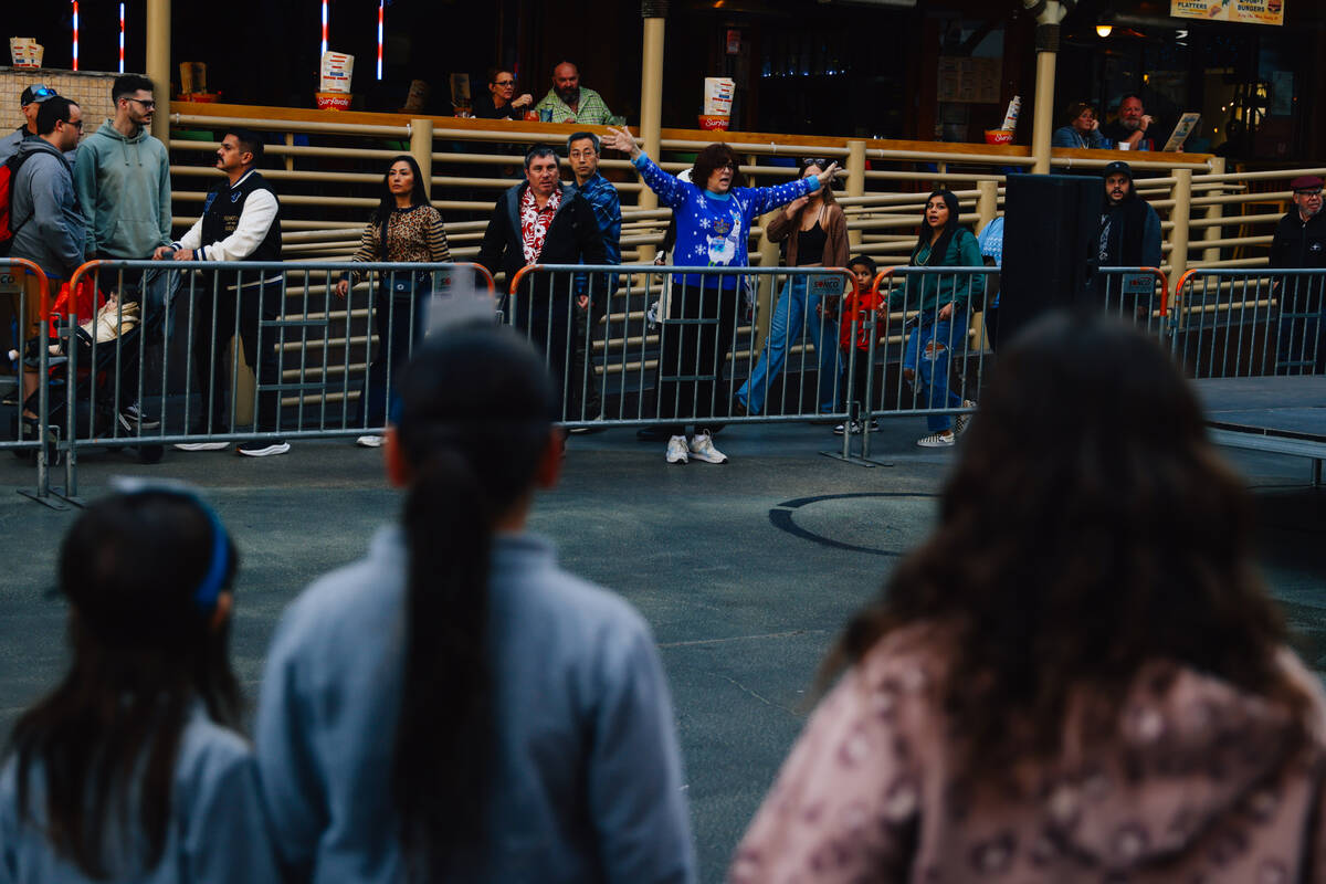 People gather during the Fremont Street Experience menorah lighting Sunday, Dec. 14, 2025, in L ...
