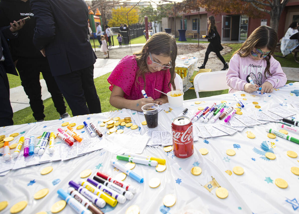 Ella, 10, works on a drawing during a pre-Hanukkah family event at Zucker Jewish Academy on Sun ...