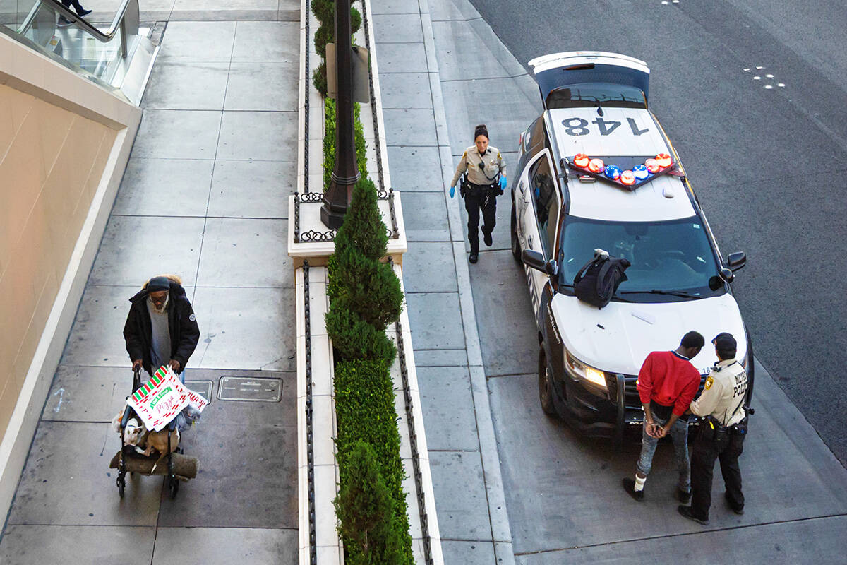 Metropolitan Police Department officers search a man who was detained near the Fashion Show Mal ...