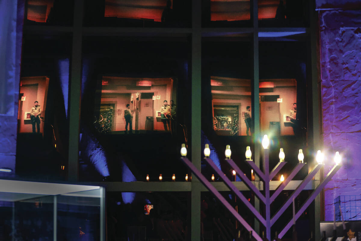 Metro officers are reflected in windows as they watch over an event for the second night of Han ...