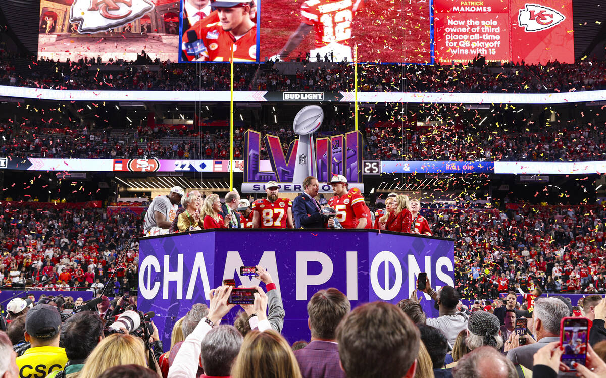 Kansas City Chiefs quarterback Patrick Mahomes (15) holds the Vince Lombardi Trophy after winni ...
