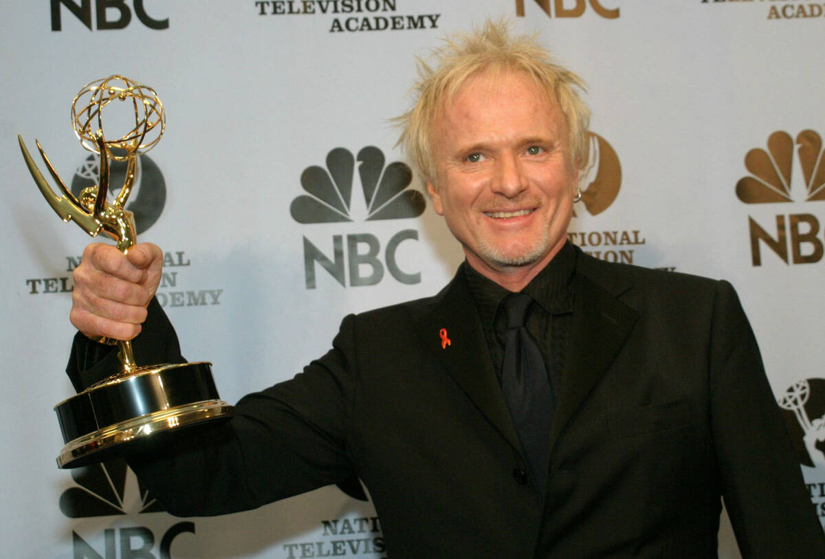 Anthony Geary holds up his Emmy as poses for photographers after winning "Outstanding Lead Acto ...