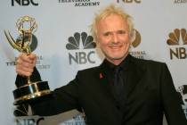 Anthony Geary holds up his Emmy as poses for photographers after winning "Outstanding Lead Acto ...