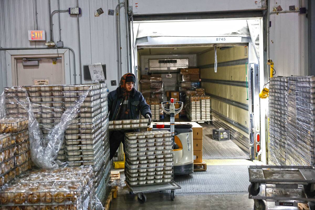 Dock workers pack meals into trucks at CCSD’s Central Kitchen Thursday, Nov. 13, 2025 in ...