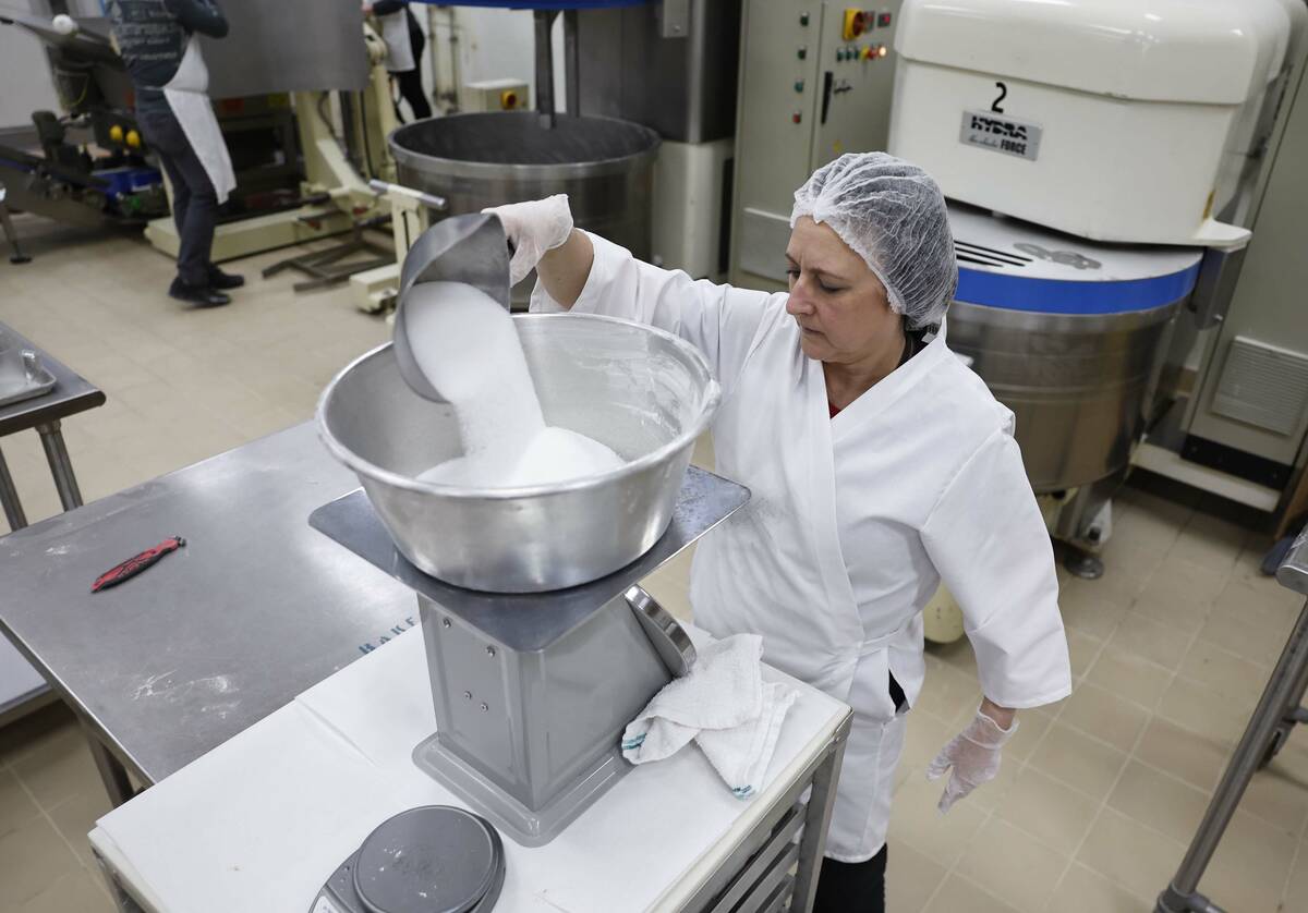 A food service worker measures salt at CCSD’s Central Kitchen Thursday, Nov. 13, 2025 in ...