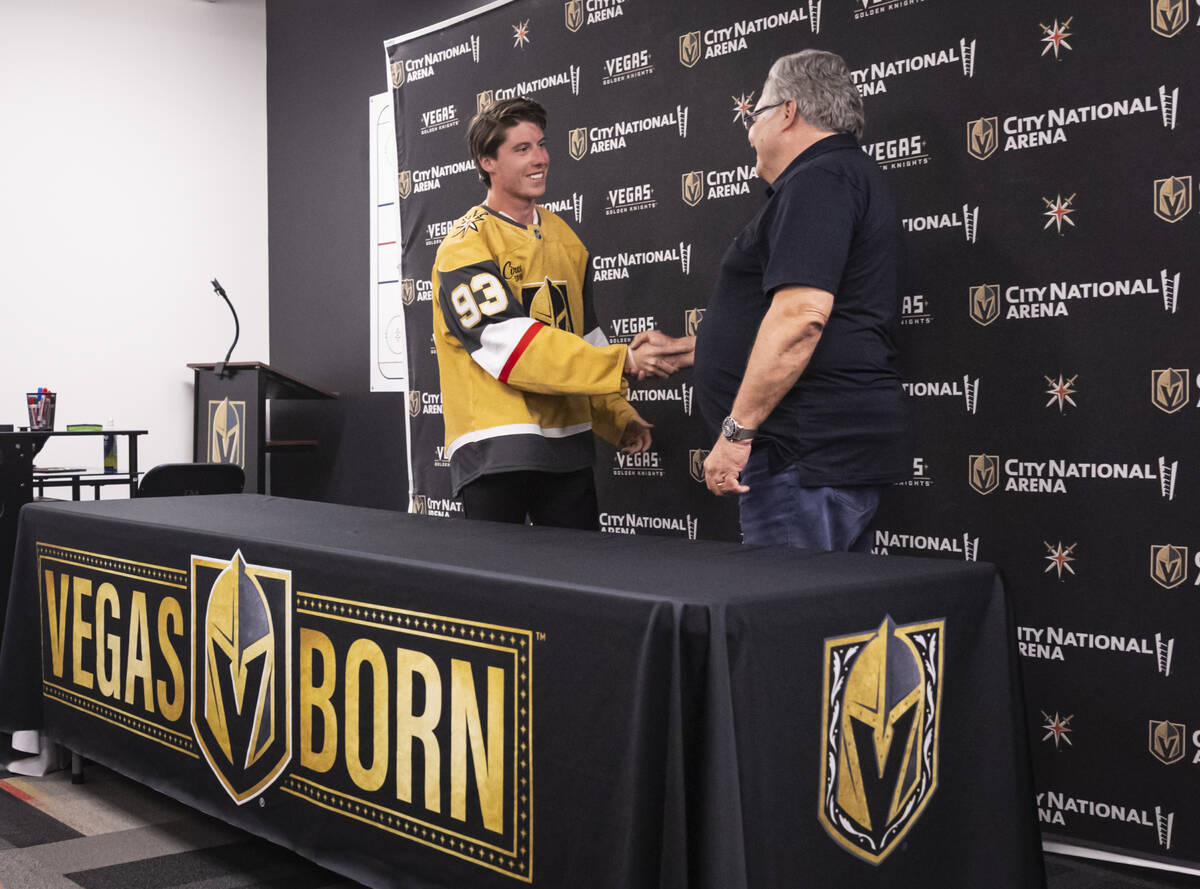 Newly acquired Golden Knights forward Mitch Marner, left, shakes hands with Golden Knights gene ...