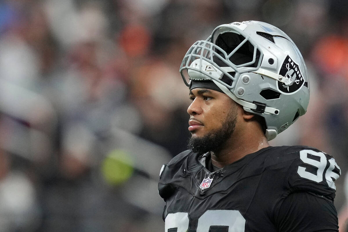Las Vegas Raiders defensive tackle Jonah Laulu (96) looks on during the first half of an NFL ga ...