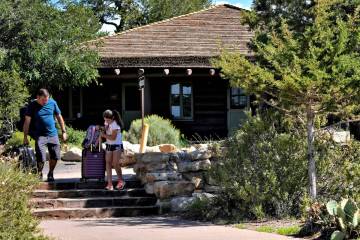 Guests exit Bright Angel Lodge on Thursday, Aug. 29, 2024, in Grand Canyon, Ariz. (AP Photo/Mat ...