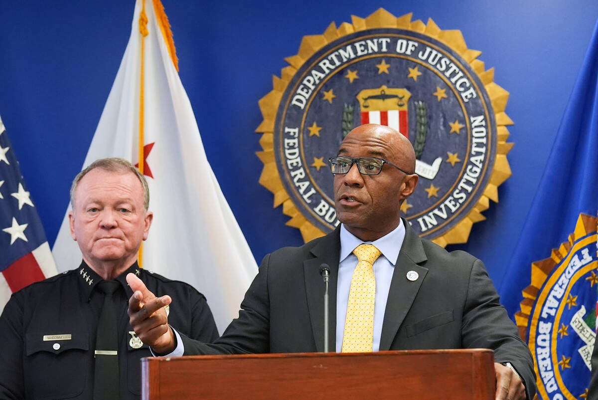 FBI Assistant Director in Charge Akil Davis, right, speaks in front of LAPD Chief Jim McDonnell ...