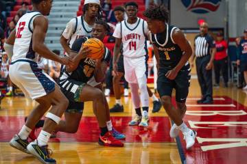 Losee’s Jaylin Trotter (32) looks for an open pass during a basketball game at Liberty H ...