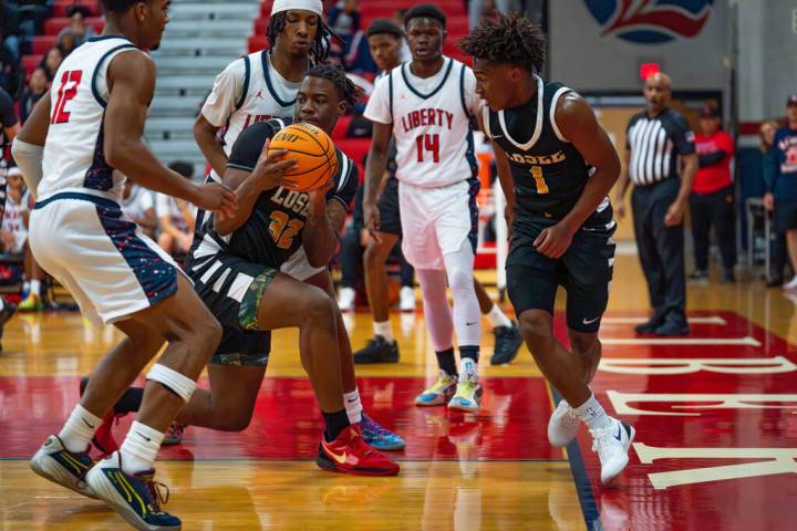 Losee’s Jaylin Trotter (32) looks for an open pass during a basketball game at Liberty H ...