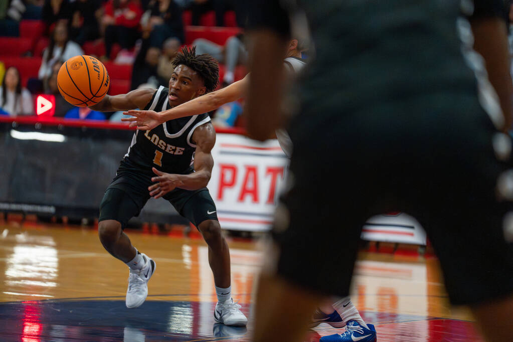 Losee point guard DJ Hunter (1) takes the ball across the court during a basketball game at Lib ...