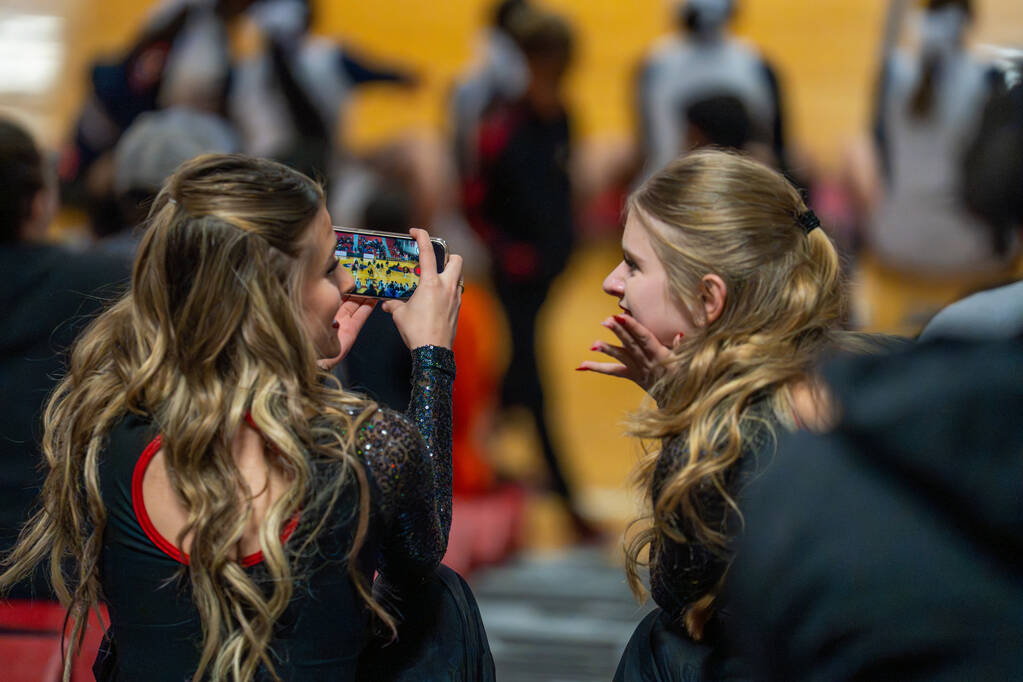 Teammates record the Liberty High School dance team’s halftime performance during a bask ...