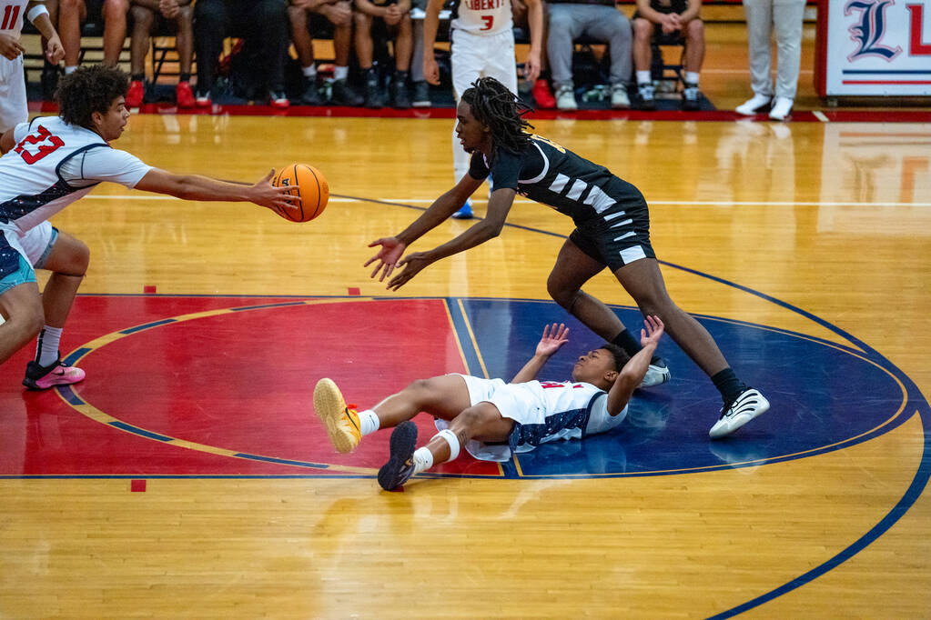 Liberty forward Maison Martin (23) tries to tap the ball away during a basketball game against ...
