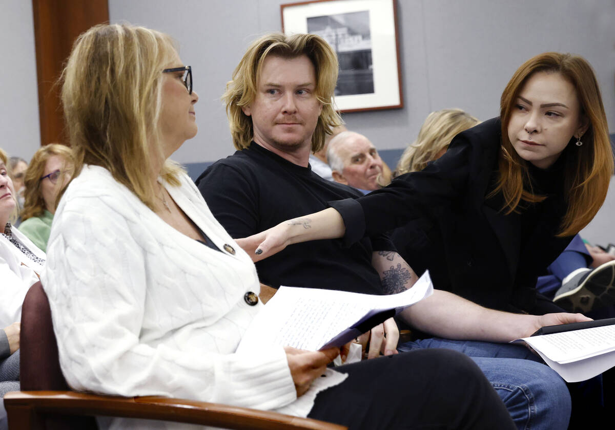 Crystal Probst, the widow of Andreas Probst, left, is comforted by her children Michael and Tay ...