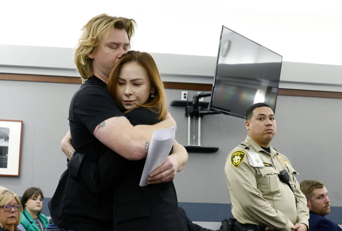 Taylor Probst, the daughter of crash victim Andreas Probst, is hugged by her brother Michael af ...