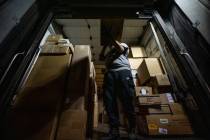 Lana Provost, a UPS package handler, loads packages into a truck at the UPS Centennial Ground H ...