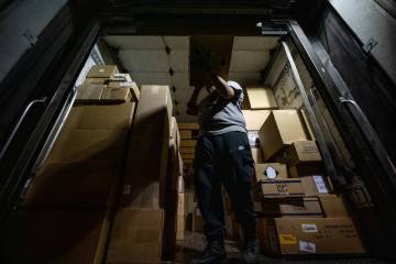 Lana Provost, a UPS package handler, loads packages into a truck at the UPS Centennial Ground H ...