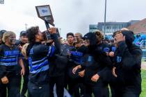 Basic's Tate Southisene (2) kisses the trophy as he and teammates celebrate their extra-in ...