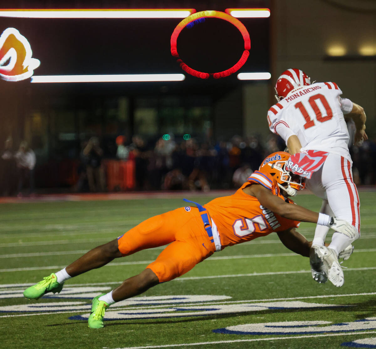Bishop Gorman defensive back Jett Washington (5) tackles Mater Dei quarterback Ryan Hopkins (10 ...