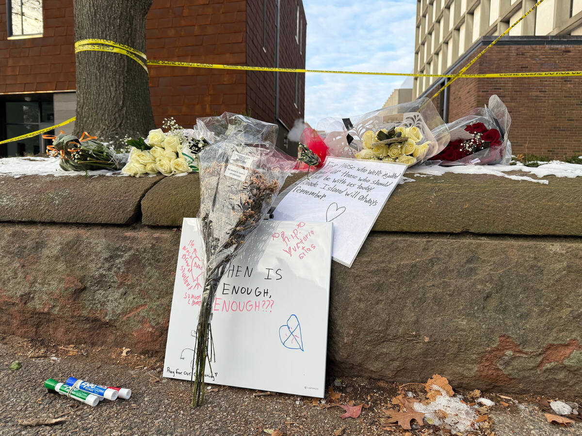 A memorial of flowers and signs lay outside the Barus and Holley engineering building at Brown ...