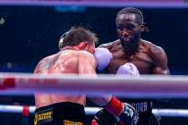 Canelo Alvarez takes a punch to the face from Terence Crawford during their undisputed super mi ...