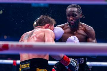 Canelo Alvarez takes a punch to the face from Terence Crawford during their undisputed super mi ...