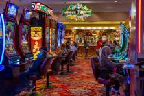 People play slots as others await a table in the Garden Buffet within the South Point on Friday ...