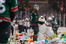 Silver Knights forward Kai Uchacz (77) holds a giant stuffed toy dog after Lucky Launch during ...
