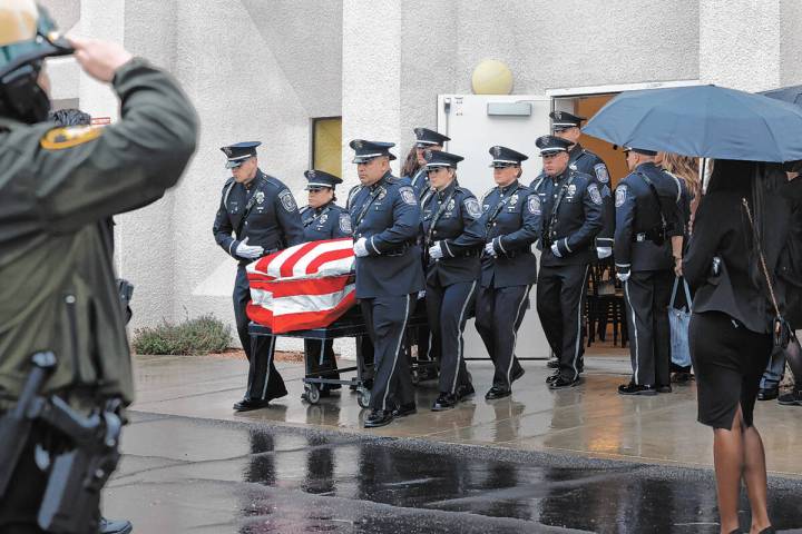 Honor Guard members carry the casket of slain North Las Vegas police officer Jason Roscow, 46, ...
