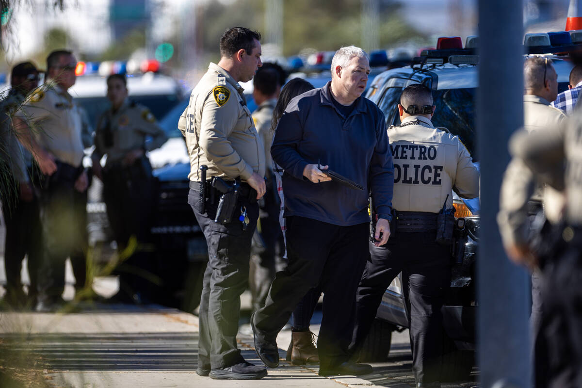 Metropolitan Police Department officers along with North Las Vegas Police officers investigate ...