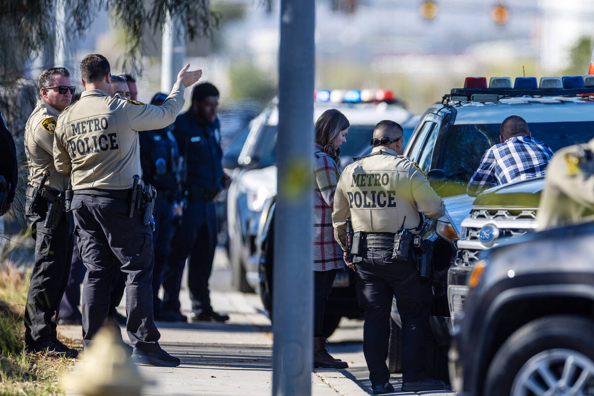 Metropolitan Police Department officers along with North Las Vegas Police officers investigate ...