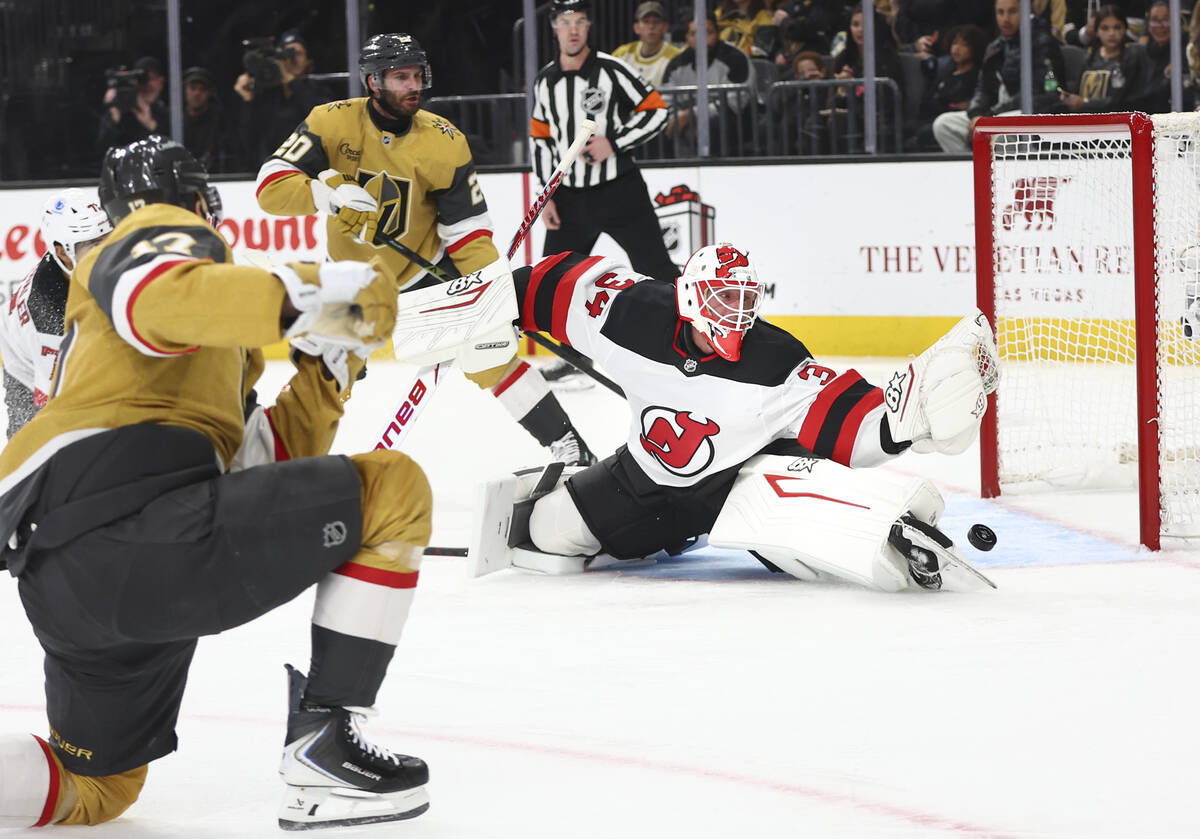 New Jersey Devils goaltender Jake Allen (34) blocks a shot from Golden Knights defenseman Ben H ...
