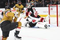 New Jersey Devils goaltender Jake Allen (34) blocks a shot from Golden Knights defenseman Ben H ...